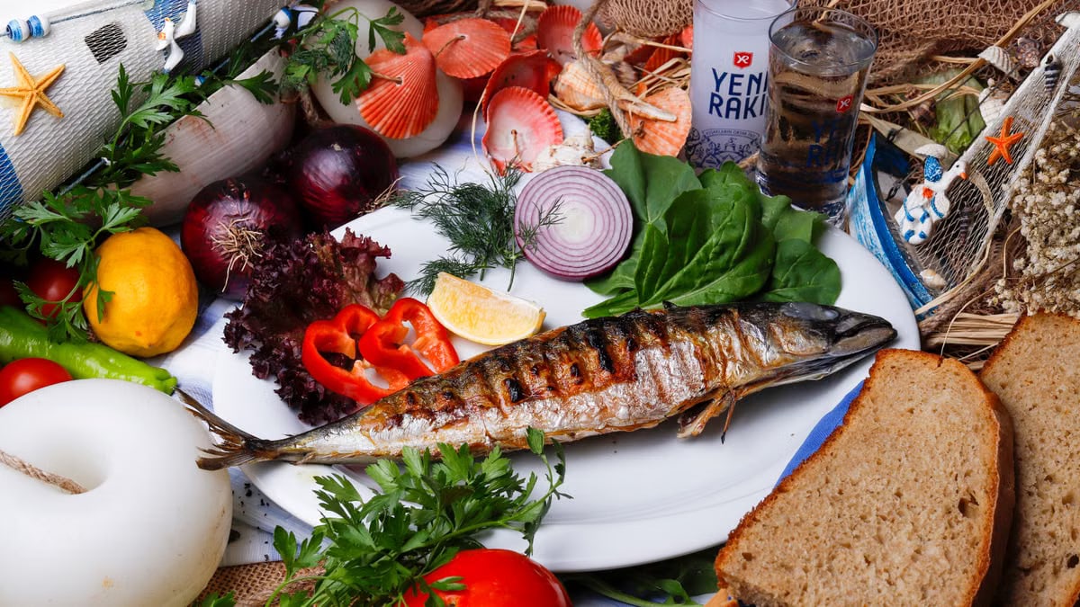 Delicious grilled fish served with fresh Mediterranean vegetables and bread.